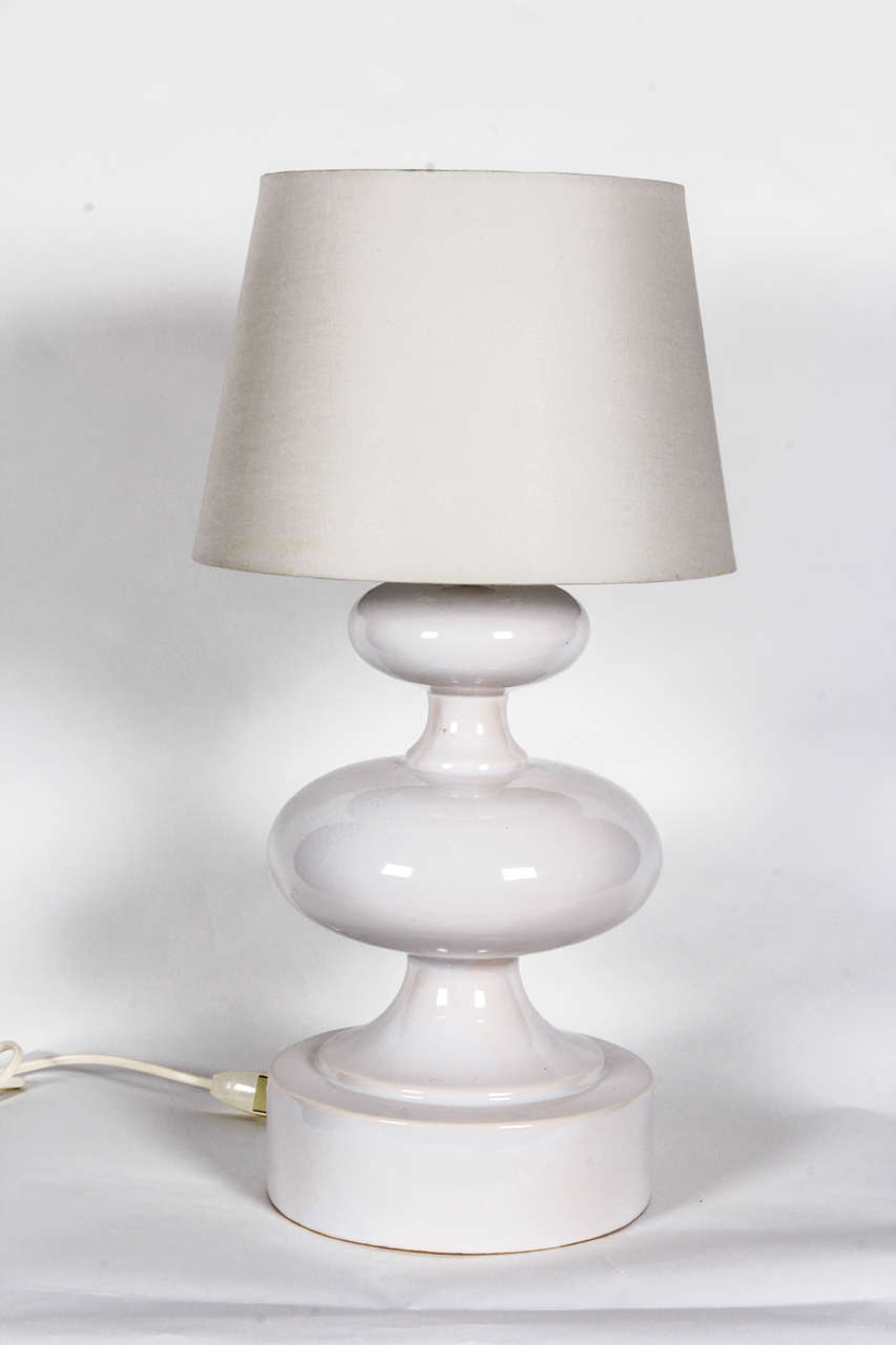 Sculptural white ceramic table lamp by Faiencerie de Charolles.  Signed.  France, circa 1970.  Signed.  Includes white paper shade.

Dimensions:
18 inch height with shade