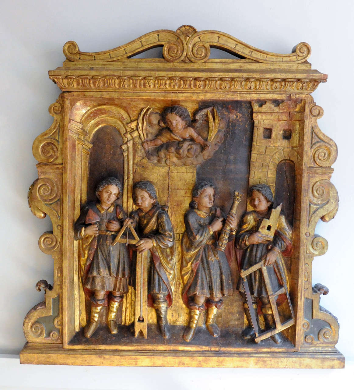 original estofado polychromy on oak

Depicting from left to right, a stone mason, an architect, a sculptor and a carpenter, the quattro Coronati, patron saints of builders and masons. This relief possibly was part of an altar that was commissioned