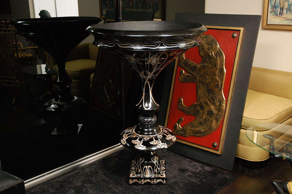 Oversized black lacquer planter with intricate flower and stylized designs in mother of pearl inlays.