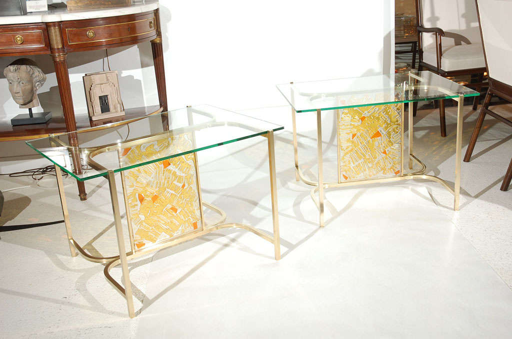 A visually striking pair of Italian brass, lucite and glass side tables.  Lucite panels where created to resemble stained glass with yellow and orange hues.