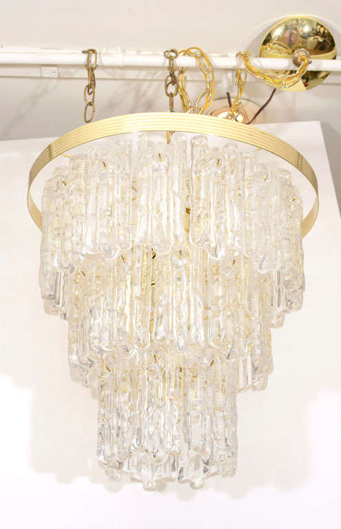 Beautiful waterfall design chandelier, reminiscent of Kalmar. This is a gorgeous piece, perfect for adding drama to a space. Consists of 32 pieces of lucite in the form of dripping ice, hanging in three tiers.

Chandelier has 8 E-12 candelabra