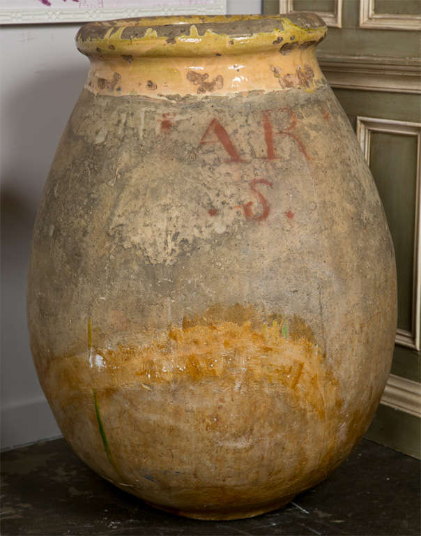 French Biot oil jar, c. 1750-1800,of large proportions from the south of France, with the typical yellow glazed rim and the chateau mark.