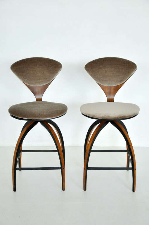 Pair of counter height swivel stools by Norman Cherner for Plycraft.  Fully restored walnut frames with new upholstery.