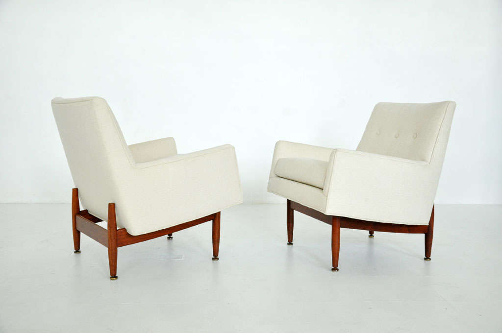 Pair of lounge chairs designed by Jens Risom.  Fully restored.  Walnut frames with newly upholstered seats.