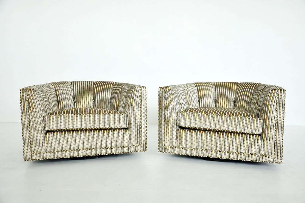 Pair of mid-century swivel lounge chairs.  Newly upholstered in striped textured velvet.