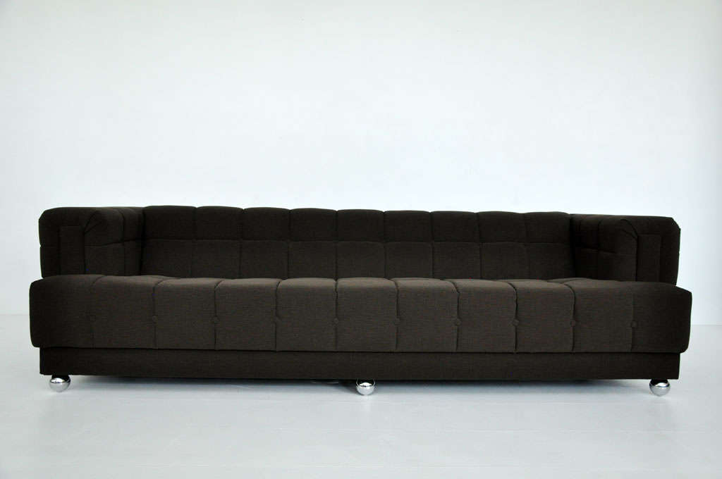 1960s Mid-Century Modern Chesterfield sofa. Newly upholstered with new chrome ball feet. Flat arm and back allow for additional seating.  Design is reminiscent of Edward Wormley for Dunbar 