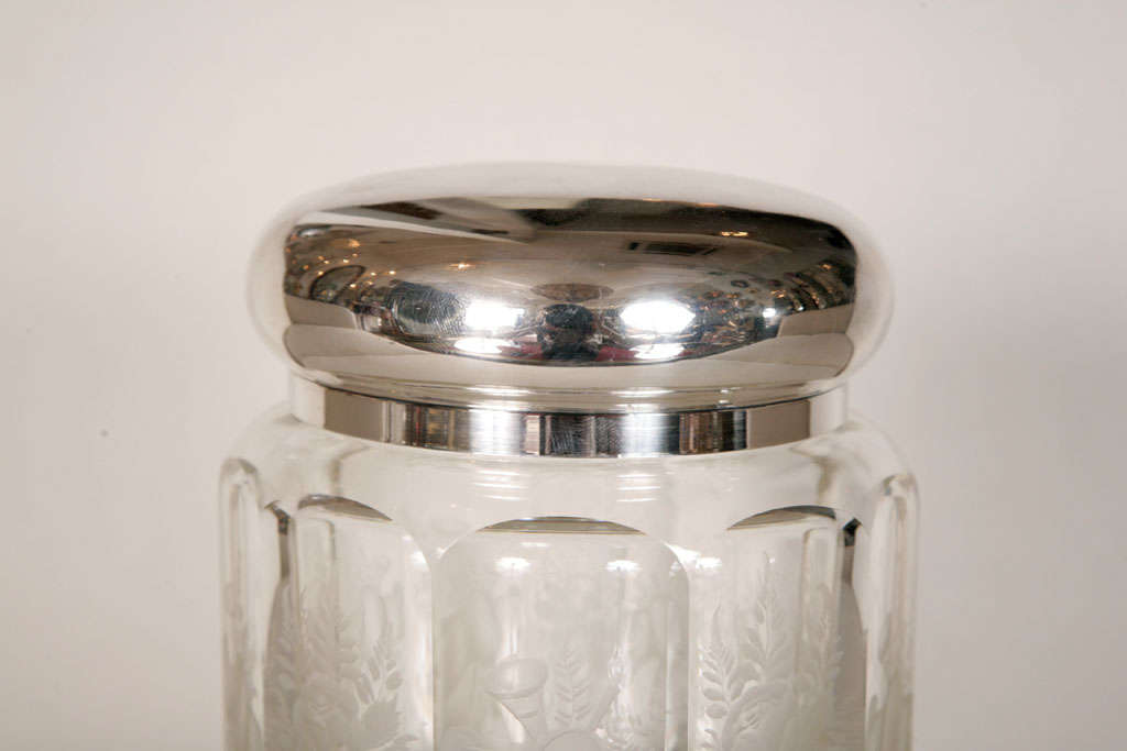 This is actually a French circa 1930's biscuit jar but is perfect for the bathroom or dressing table. The glass etched sides are etched with flowers and the silver lid covers an additional silver rim on the glass.