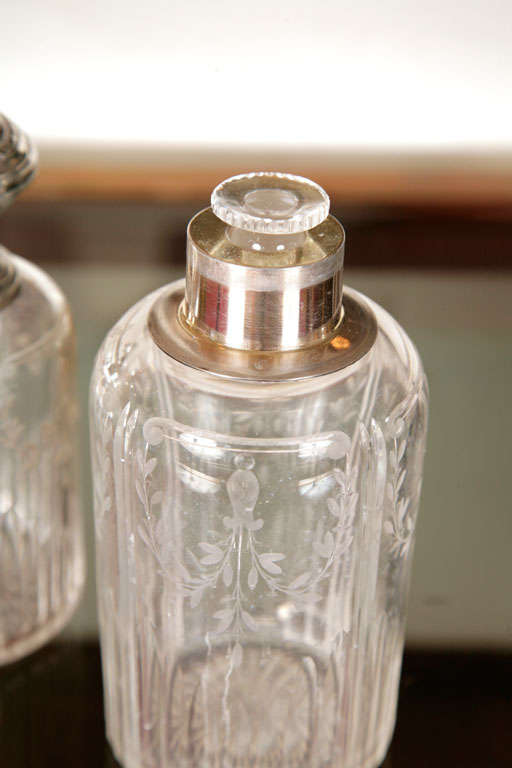 Silver dressing table set, comprising two bottles, one circular box and one rectangular box. Both the glass and silver tops are delicately etched.
Tallest bottle 6.7 inches