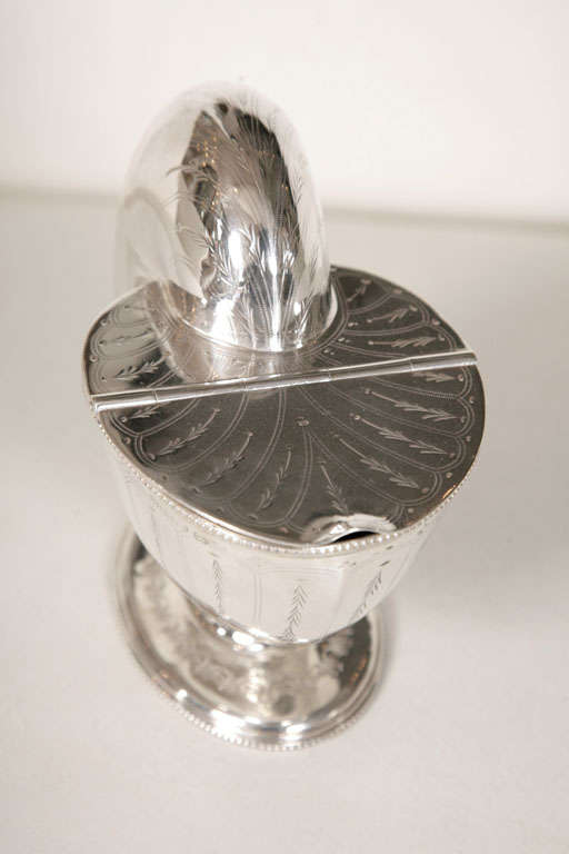 England, c.1930's, silver plated, in the form of a large shell on a circular base, the slim lid lifting to reveal a small compartment inside. The Victorians used these are spoon warmers