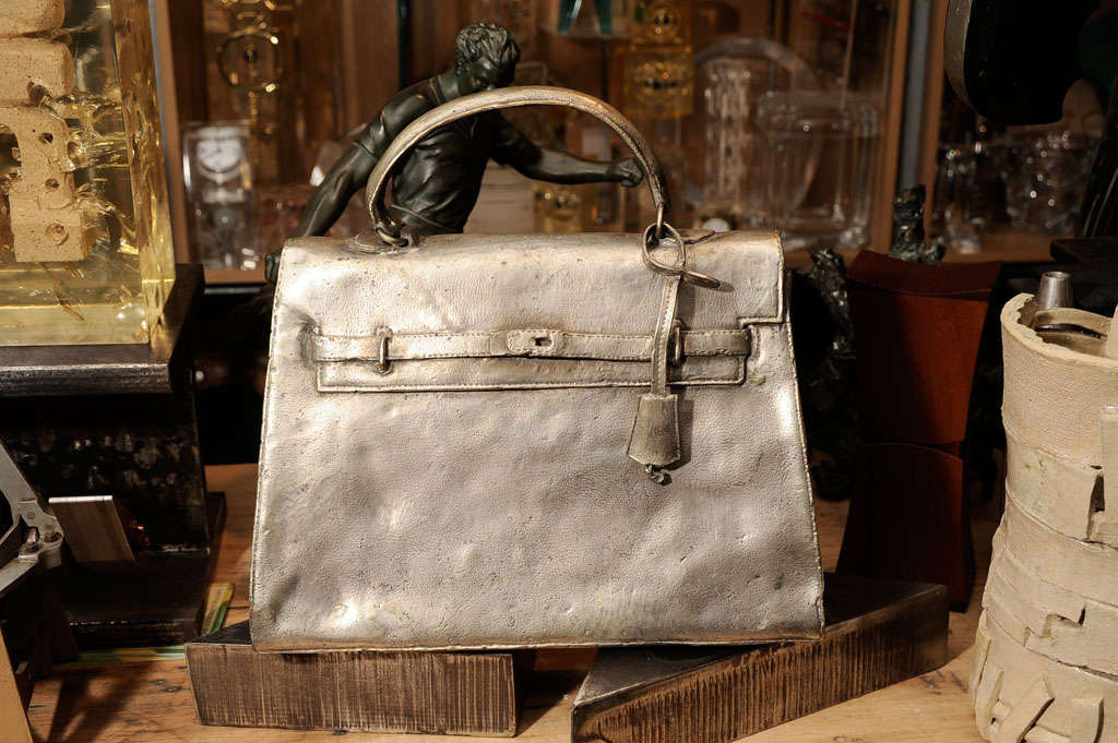 An amazing, to scale, bronze casting of a 1960s Hermes Kelly bag silver plated. It must weigh 35 lbs. By Christian Maas.
