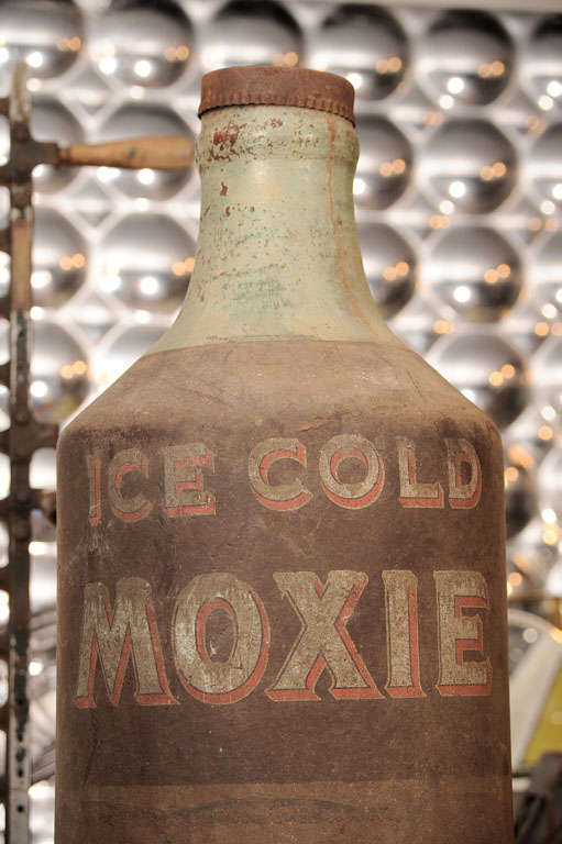 Moxie is a carbonated beverage that was one of the first mass-produced soft drinks in the United States. It continues to be regionally popular today. It is the main ingredient in the New Englander cocktail. This trade sign is probably circa the