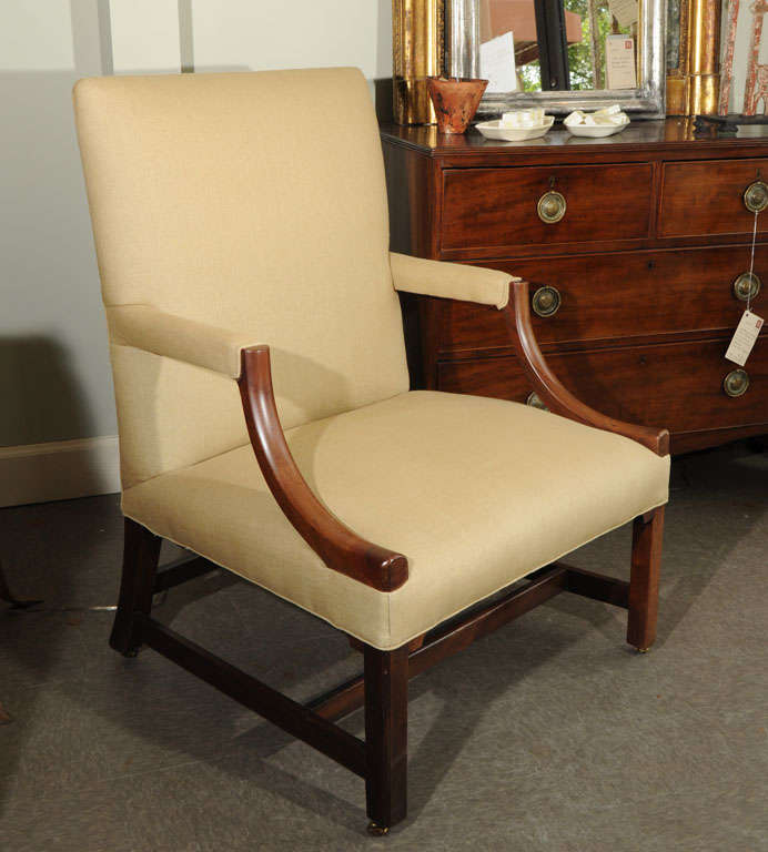 Classic and elegant George III-style Gainsborough chair, mahogany, on casters. Sturdy mortise and tenon construction. England, circa 1850. New linen upholstery