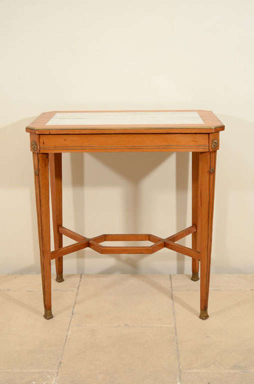 A 19th century Continental ash side table with brass stringing and rosettes and an inset marble top.