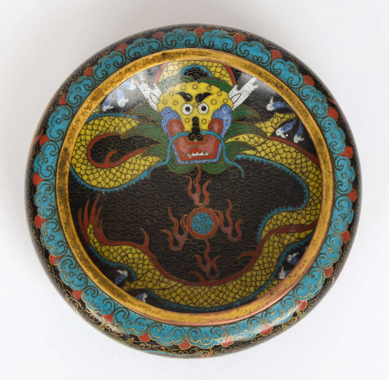 A quality shallow CLOISONNE bowl made in China in the early 19th Century.

The bowl is of circular with a short foot. 

This is a beautifully made and designed piece painted in rich enamels.
The decoration shows mythical five clawed dragons
