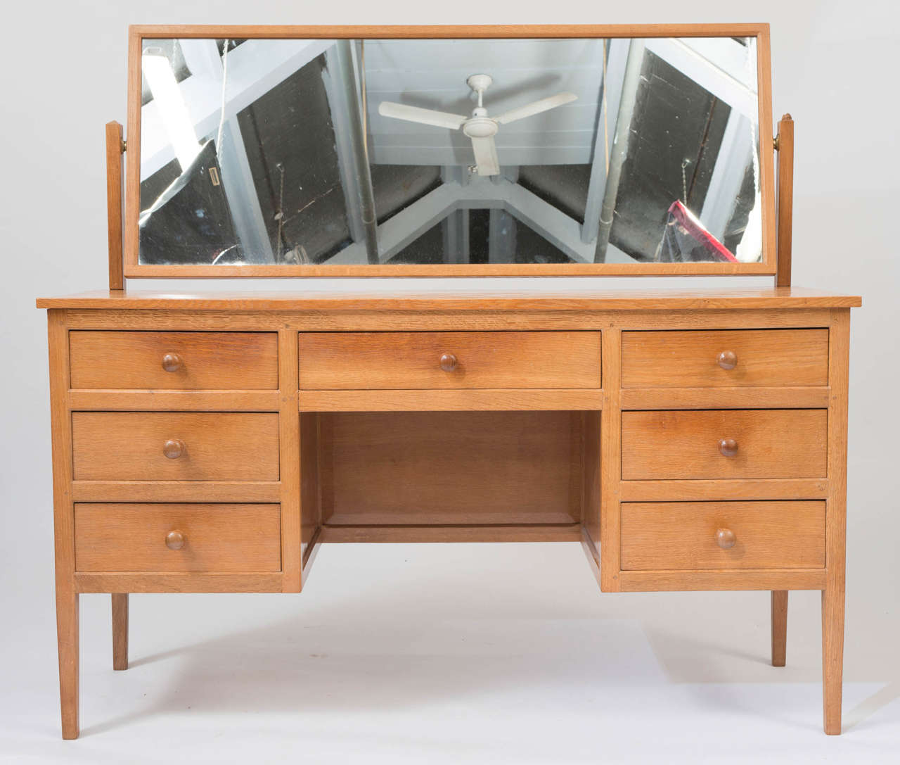 A Robert “Mouseman” Thompson Bespoke Oak Dressing Table of unusual wide proportions.
The rectangular mirror above a central drawer  enclosed to each side by three graduating drawers. On four tapering square section legs.
Carved Mouse