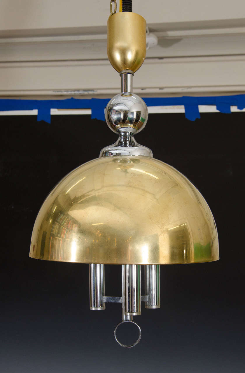 A vintage half-moon shaped brass pendant with chrome accents. This fixture takes three candelabra bulbs.

Adjustable Height: 27" - 30" x 20" D.