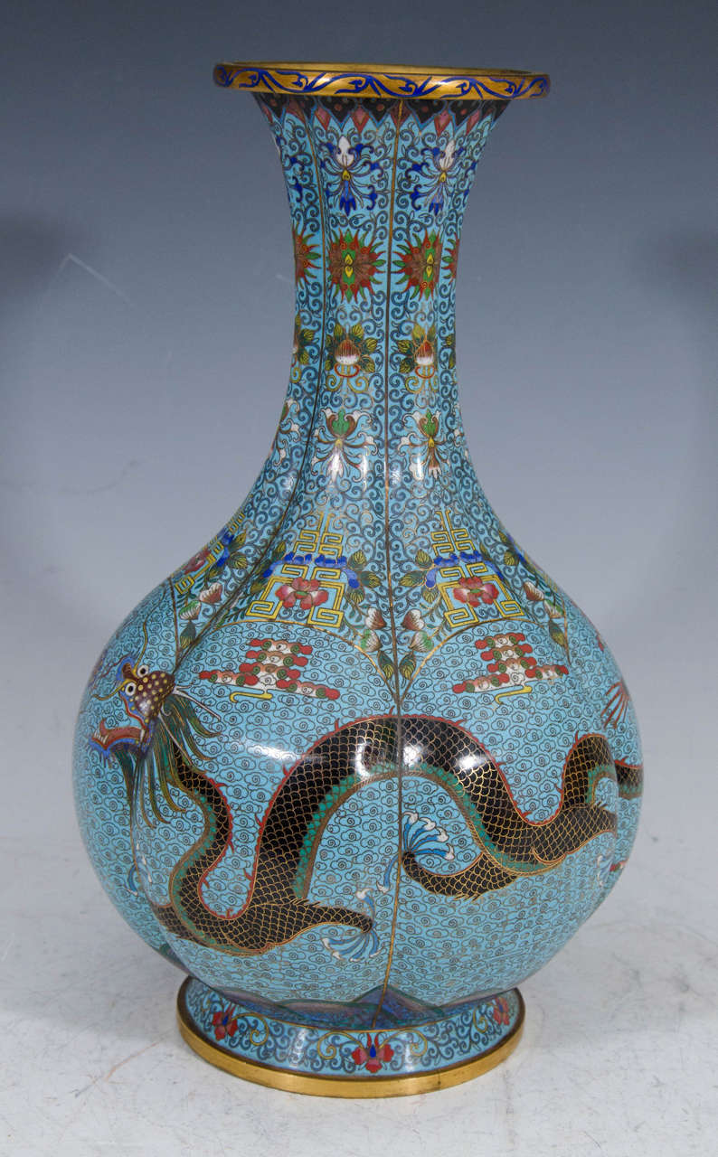 A blue enamel over brass Chinese vase with dragon motif, circa 1890.

Good condition with age appropriate wear and patina.