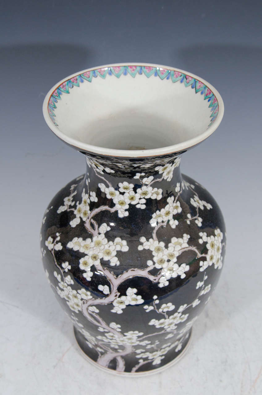 A 19th century Chinese vase with cherry blossoms on a black background.

Good condition with age appropriate wear.
