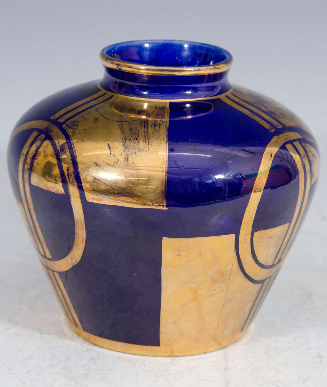 An Art Deco Sevres vase in cobalt blue with a geometric design.

Good condition with age appropriate wear.  Some paint loss.