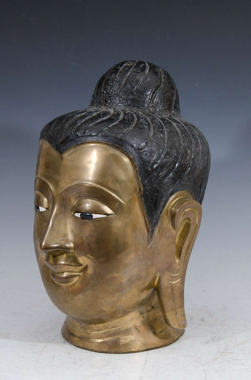 A vintage sculpture of a Burmese (Myanmar) bronze Buddha head, produced within the early to mid 20th century period. Good condition with age appropriate patina.