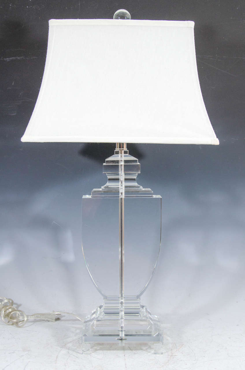 A 20th century pair of solid crystal flat urn table lamps.

Dimensions without shade: 22