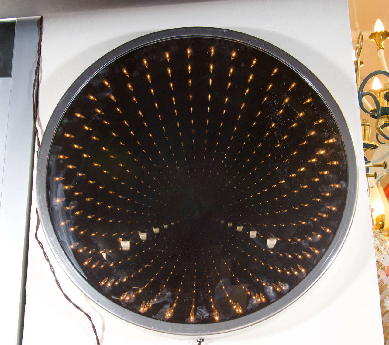 A vintage lighted infinity wall mirror or sculpture by Earl Reiback titled, 
