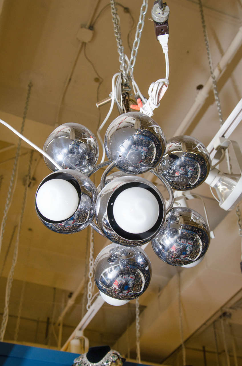 A vintage sculptural chrome pendant light with eight globes.
