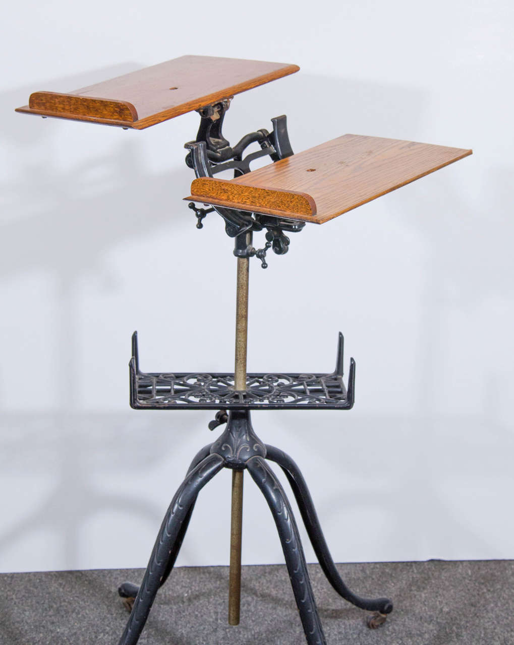 An antique iron and oak adjustable height dictionary stand. Can also be used as a book, menu, or music stand.

Good condition with age appropriate wear and patina. Some nicks to wood.

23