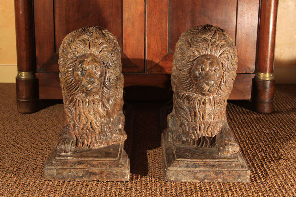 Pair of Scottish Terra Cotta Lions with Salt Glazed Finish.

These are a true pair of lions - one lion is clutching the ball in the right paw and the other with the left paw.

The earthy brown colors go well modern or traditional