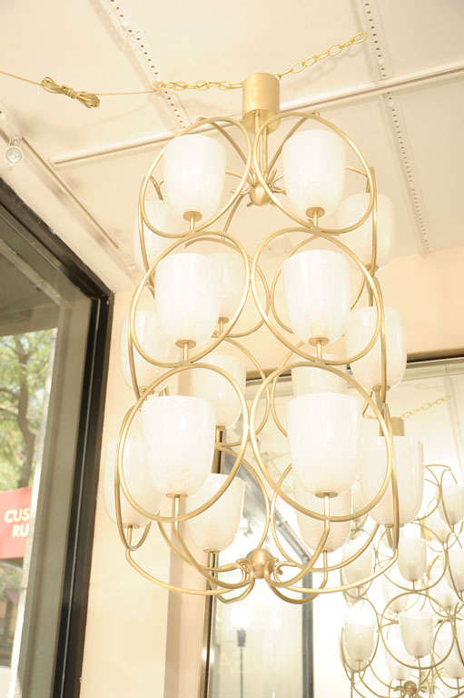 Brass Large scale brass chandelier featuring white glass shades