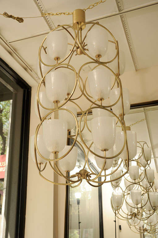 Large scale brass chandelier featuring white glass shades 1