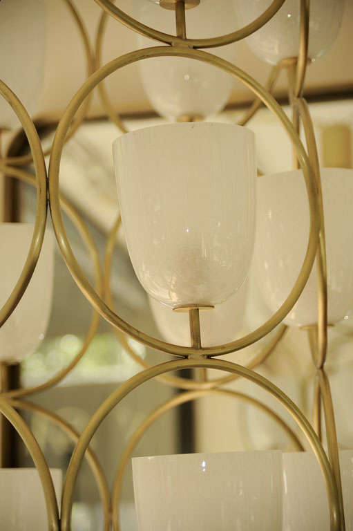 Large scale brass chandelier featuring white glass shades 3