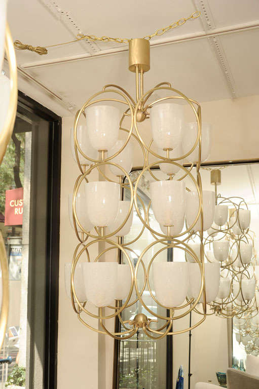 Large scale brass chandelier featuring white glass shades 4