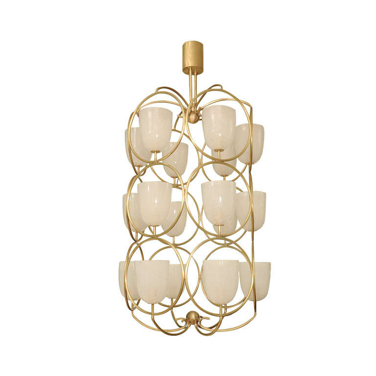 Large scale brass chandelier featuring white glass shades