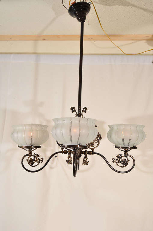 Restored Four Light, Originally Gas, Lighting Fixture with original Gas Shades.  Restored Antique Brass finish and Electrified by Brady's.