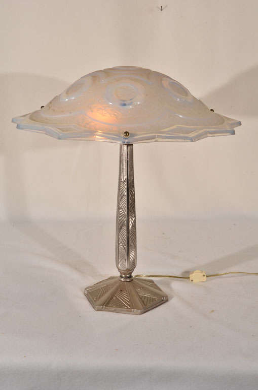 Art Deco Table Lamp, nickel plated over  Cast Bronze, displaying geometric lines in the casting with a Rene Lalique  Molded Glass Shade (unsigned)  displaying a rainbow of iridescent colors from the gold infused into the molded glass.