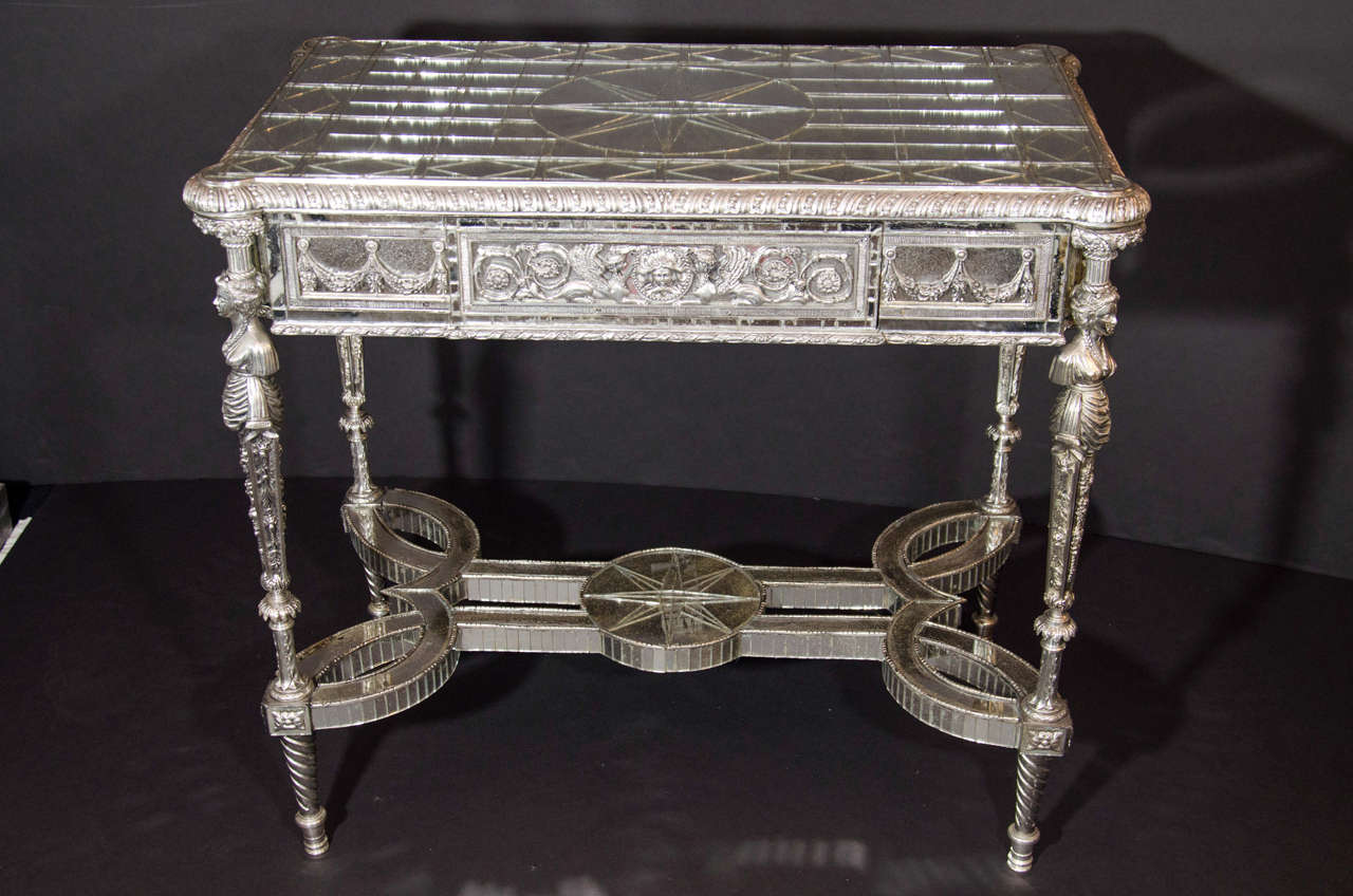 A pair of unique French Louis XVI style silvered bronze mirrored rectangular center or side tables of great detail embellished with figural silvered bronze mounts and further adorned with geometric antique mirrored inlays of unusual pattern.