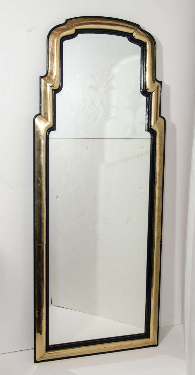 A pair of unique antique French Art Deco gilt bronze and ebony mirrors of unusual shape, attributed to Jansen, Paris.