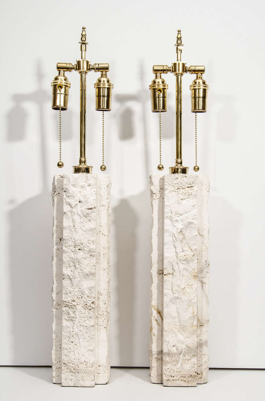 Pair of limestone table lamps with brass hardware.
 
