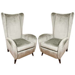 Pair of upholstered wingback chairs with wood feet