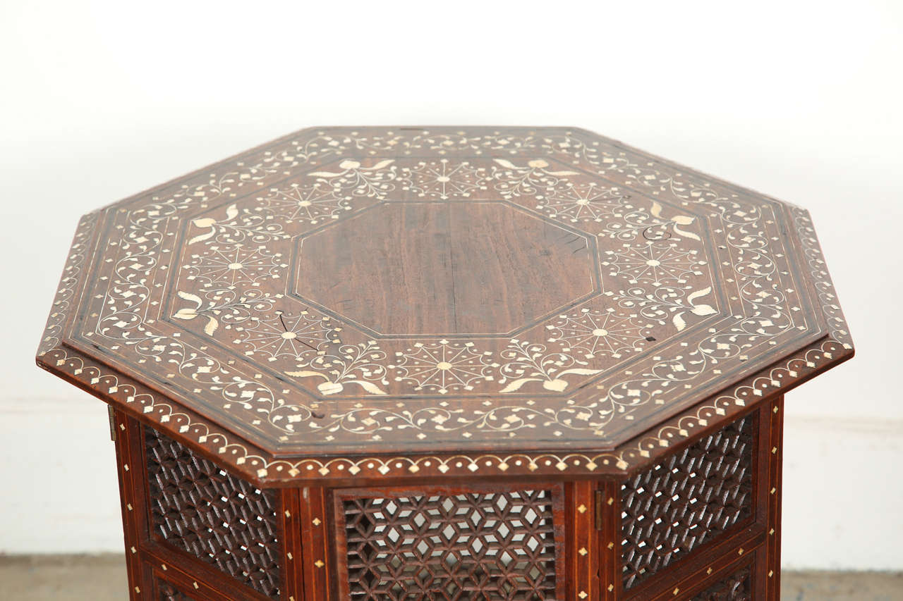 Late 19th century Anglo Indian folding Ivory Inlaid Octagonal Side Table.
Fine and elegant Anglo-Indian octagonal rosewood table with elaborate ivory and ebony inlay.The octagonal surface is finely carved and inlaid with ivory and ebony designs (