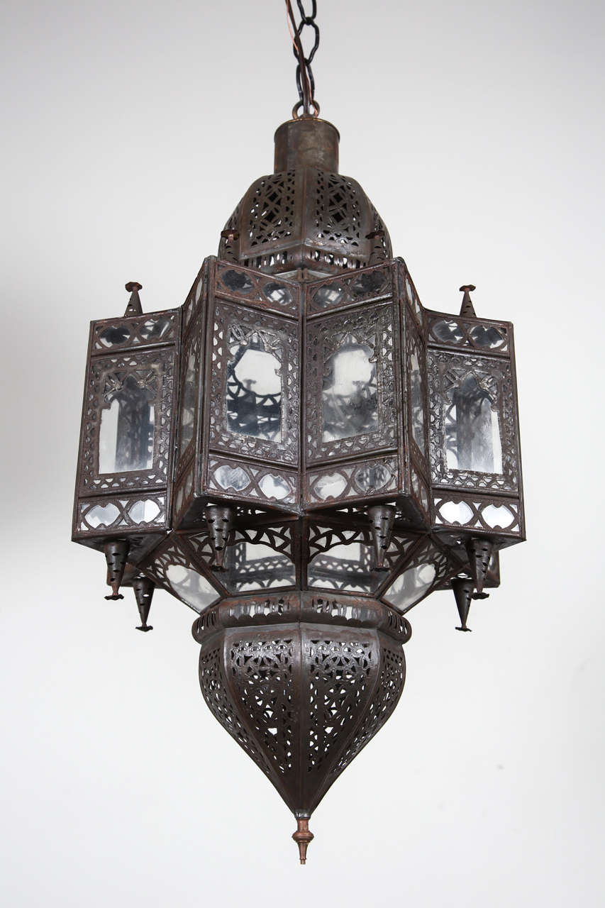 Large Moroccan Star shape lantern with clear glass multifaceted and intricate filigree work on metal, bronze patina rust finish.
Single light source one socket.up to 100 watt max.
Comes with chains and canopy, chains could be adjusted to your