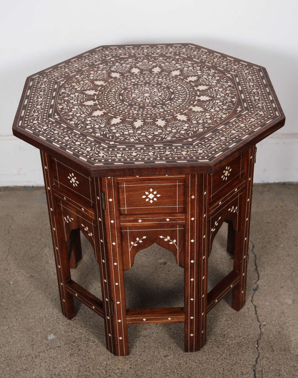 Anglo Indian folding Rosewood Ivory Inlaid Octagonal Side Table.
Fine and elegant Anglo-Indian octagonal rosewood table with elaborate bone inlay.The octagonal surface is finely carved and inlaid with bone details designs. The base fold flat.