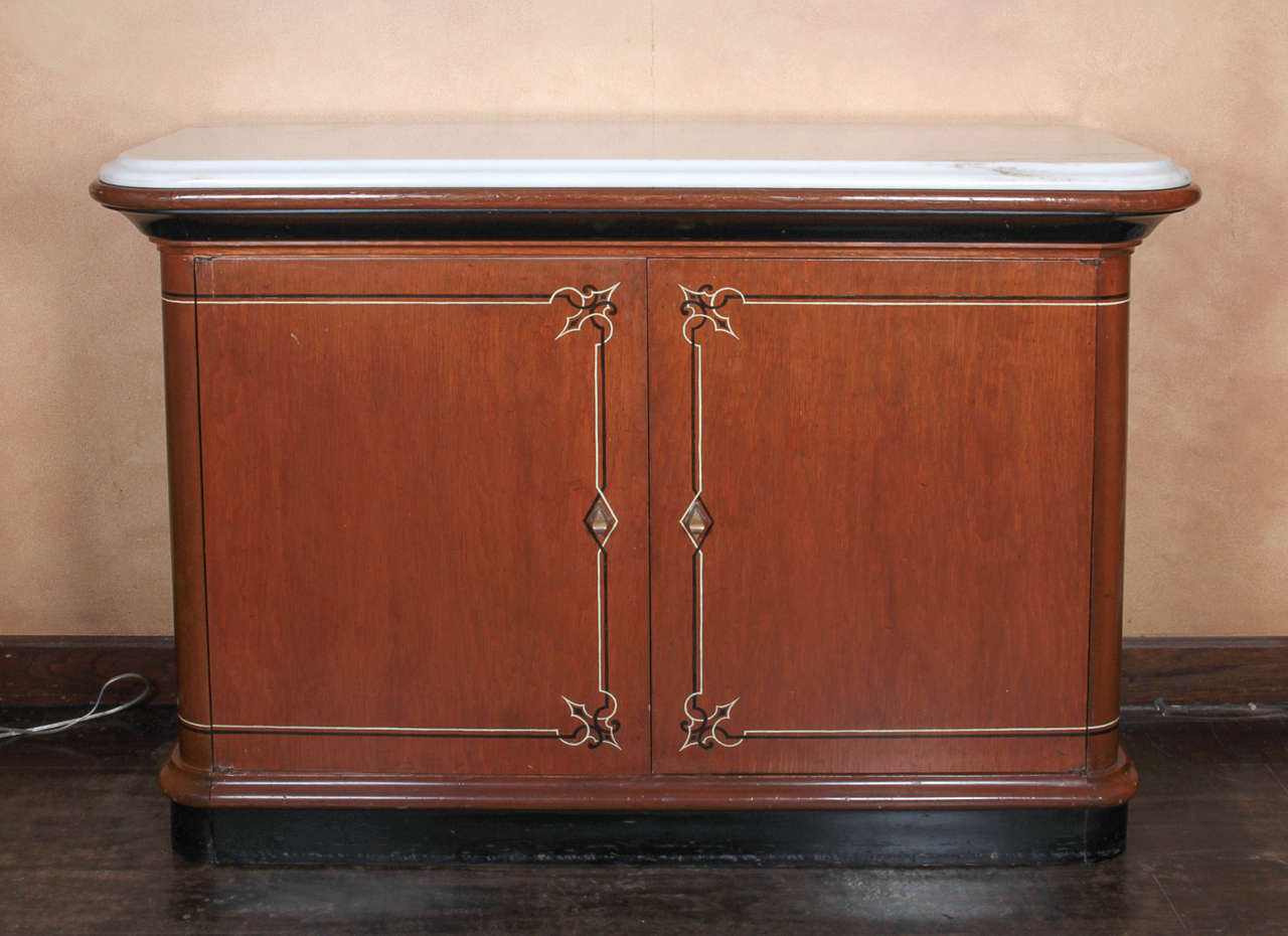 A pair of unique cabinets with white marble tops designed by John Dickinson in 1972 for his own San Francisco firehouse home. The black-and-white decorations were painted by Dickinson himself, and the original working drawing is in the San Francisco