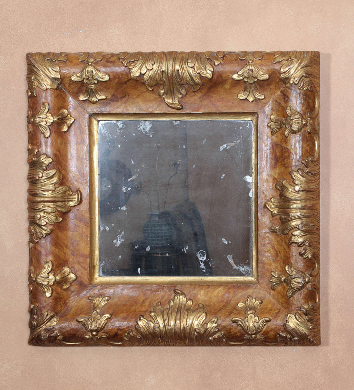 A faux-marble painted and gilded-wood Rococo mirror with a period mirror plate. Possibly made in Eastern Europe.