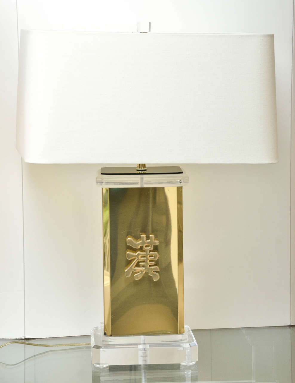 Attractive pair of brass and Lucite lamps with Asian motif attributed to James Mont.