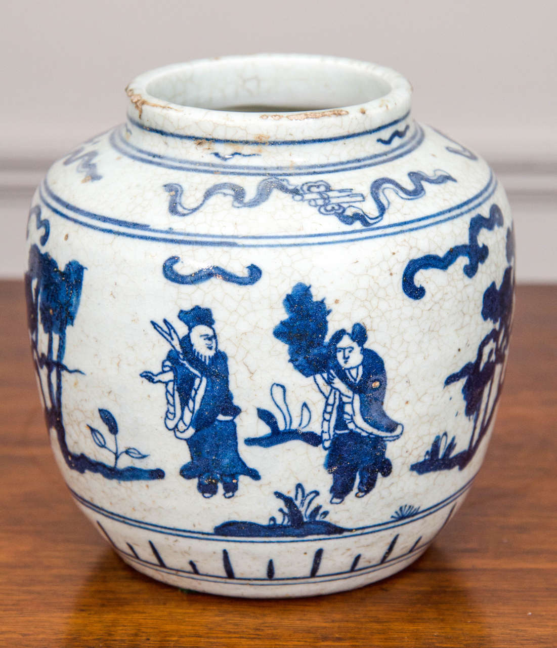 This single early 20th-century Chinese blue-and-white porcelain jar is ornamented in cobalt blue with figures in an abstracted landscape.