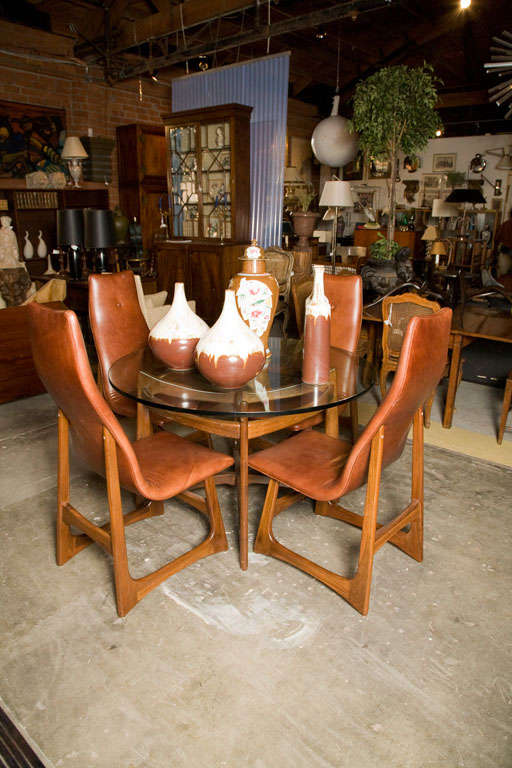 American walnut and glass top dining table and set of four highback leather chairs