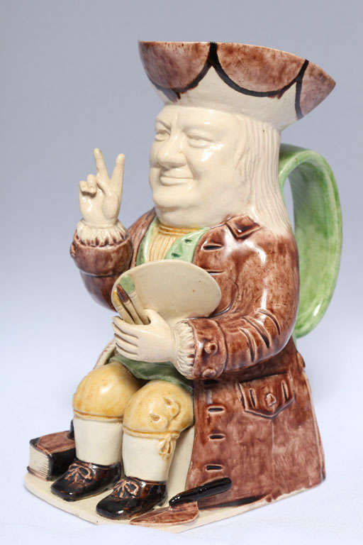 A rare Winston Churchill toby jug designed by Leonard Jarvis, depicting Churchill in his victory pose and decorated in underglaze colors