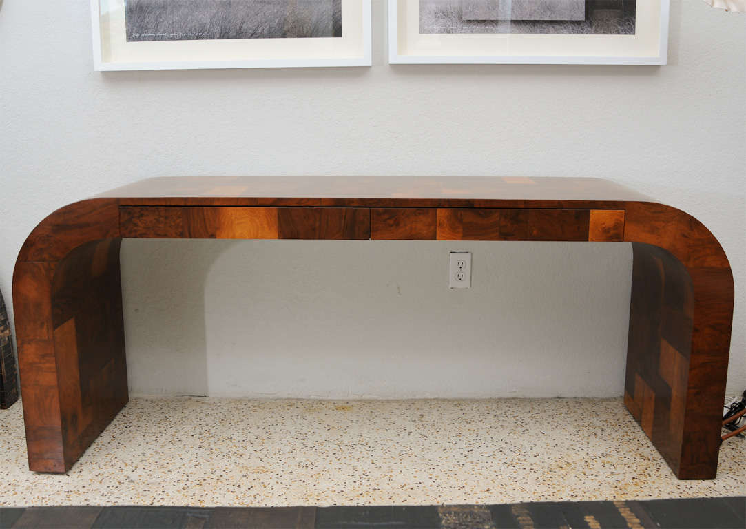 Rich olive burl signature patchwork piece by Paul Evans.  Impressively scaled waterfall design with two drawers can be used as either a console or desk. You will love the quality and beauty of this piece!